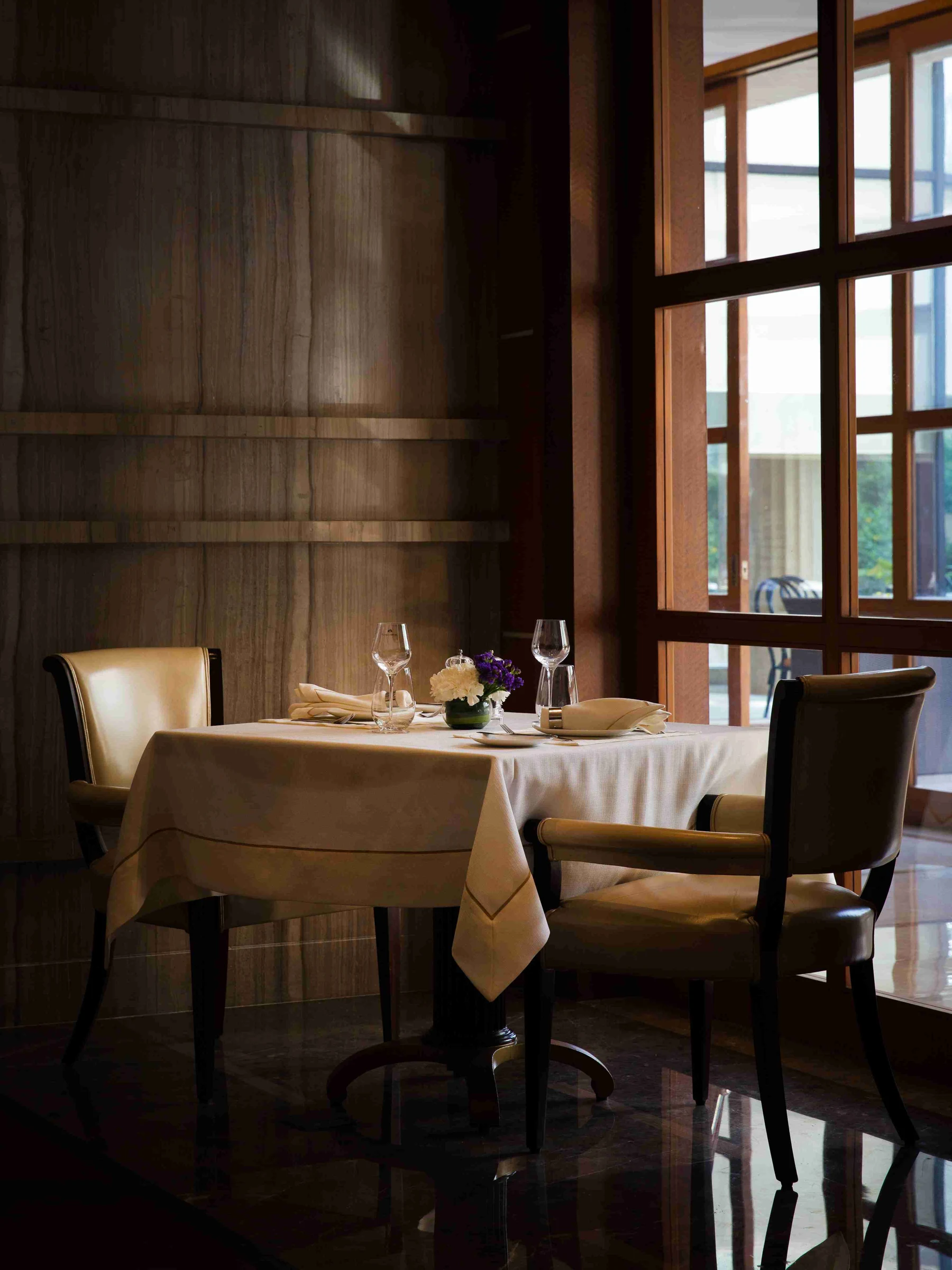 DLF The Magnolias — residents' club dining room — Residents' clubhouse reference, not the offered home. Membership, access and charges are governed by current terms.