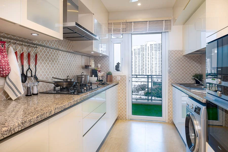 DLF The Skycourt — furnished kitchen reference — Developer gallery photograph of a furnished reference home, not the offered unit. Furniture, appliances and finishes are not included unless agreed.