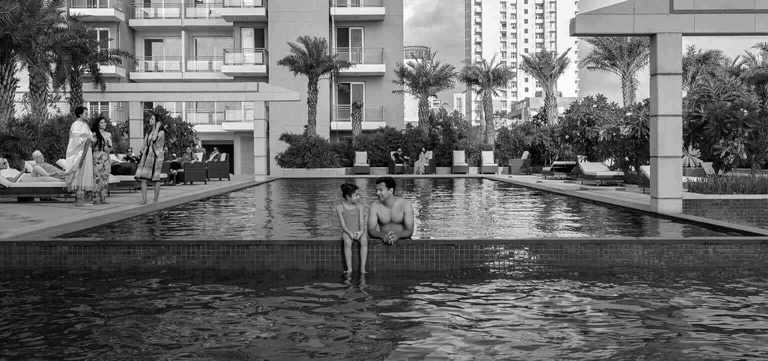 DLF The Ultima — pool and leisure reference — Developer project visual; not the offered unit. Facilities and phase access depend on the selected home.