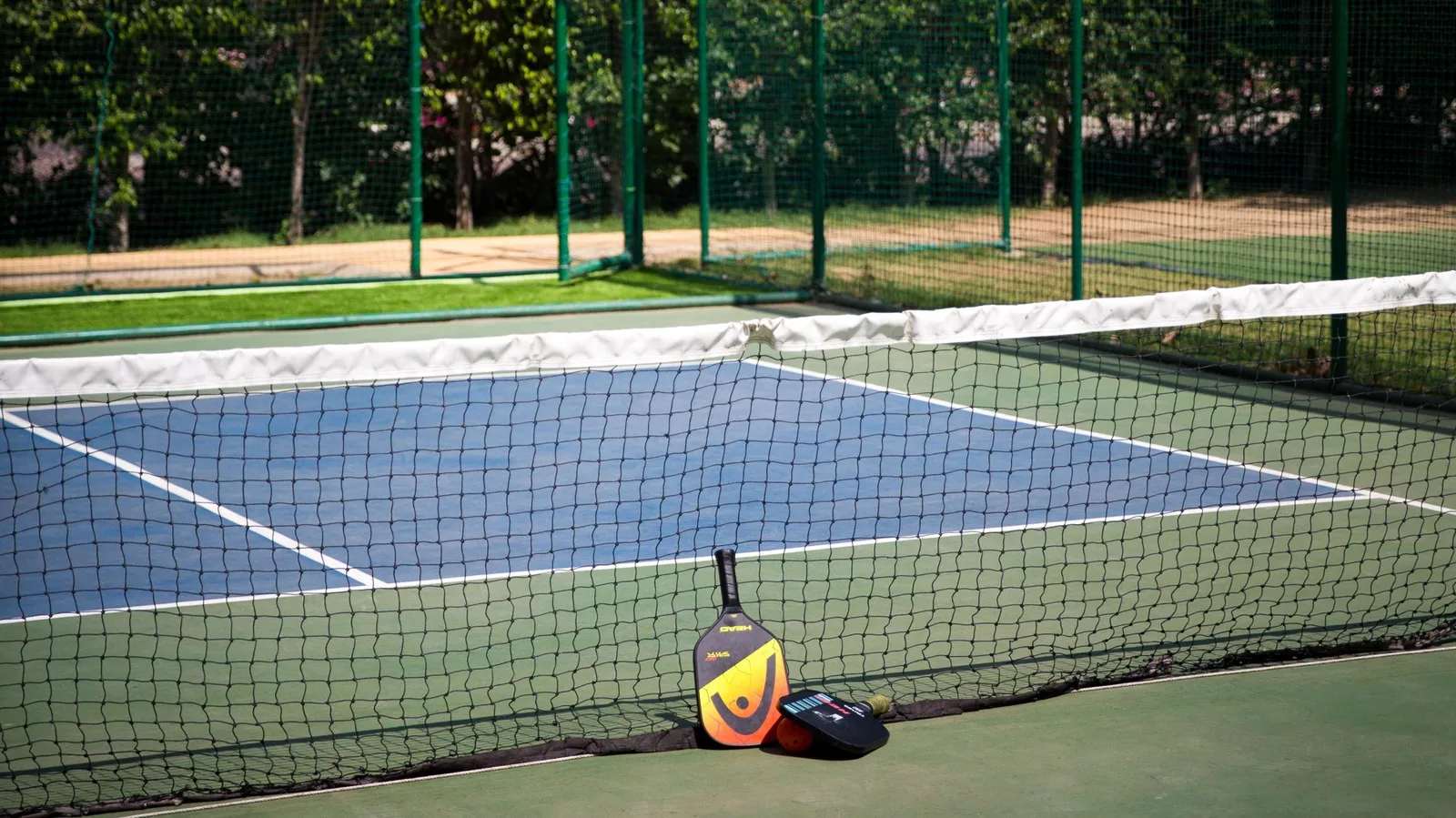 DLF The Magnolias — tennis court — DLF Hospitality club photograph; membership and access terms apply. Not the offered residence.